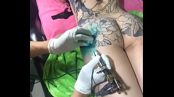 a girl making a tattoo in personal area